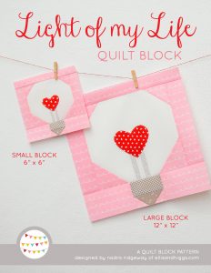 Heart Light Bulb quilt block in two sizes hanging on a wall