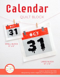 Calendar quilt block in two sizes hanging on a wall