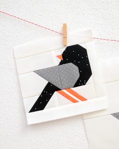 6 Inch Crow quilt block hanging on a wall