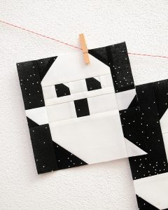 6 Inch Ghost quilt block hanging on a wall
