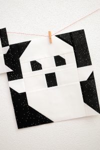 12 Inch Ghost quilt block hanging on a wall