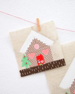 6 Inch Gingerbread House quilt block hanging on a wall