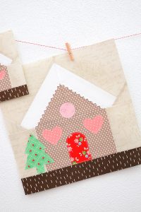 12 Inch Gingerbread House quilt block hanging on a wall