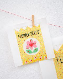 6 Inch Flower Seeds quilt block hanging on a wall