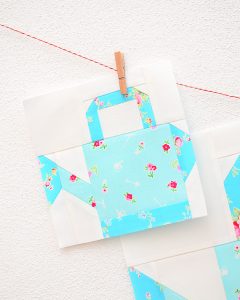 6 Inch Watering Can quilt block hanging on a wall
