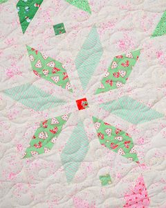 Light green star quilt block in a Christmas quilt