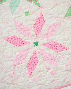 Pink star quilt block in a Christmas quilt
